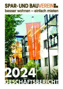 Zwei orange Fahnen vor einem Gebäude mit einem Baum